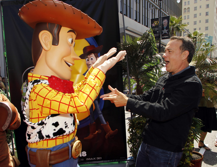 Image: Actor Hanks greets the character Woody, whose voice he plays in the film, at the world premiere of Disney Pixar's \"Toy Story 3\" in Hollywood